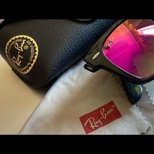 Pink Ray-Ban sunglasses with black frame.